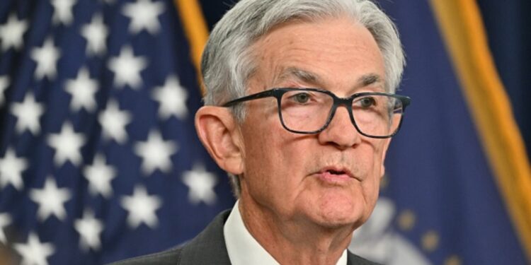 Powell sees tariffs raising inflation and says Fed will wait before further rate moves